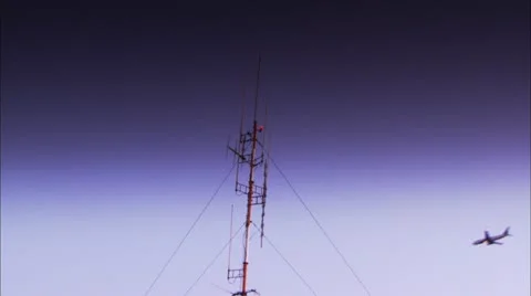 Plane Flying by Radio Tower Stock Footage 12761328