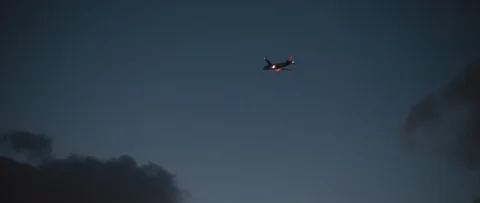 Plane flying into the sky at night, slow motion 4K Stock Footage 119309067