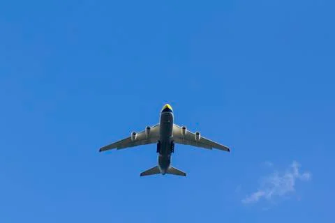 A plane is flying in the sky Stock Photos