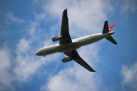 A plane flying in the sky Stock Photos