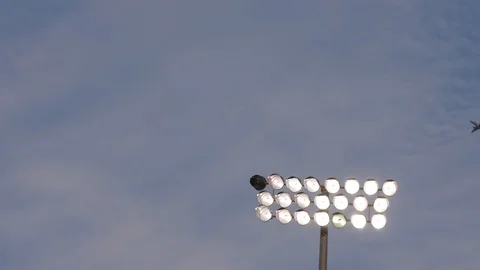 Plane flying by stadium lights Stock Footage 102132709