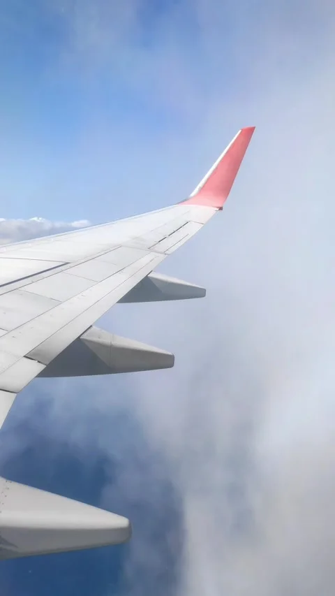 Plane flying through the clouds and over the sea. View from the window Stock Footage 251323710