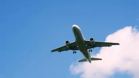 Plane flying through clouds in the sky. Jet aircraft in the air. 動画素材 77767054