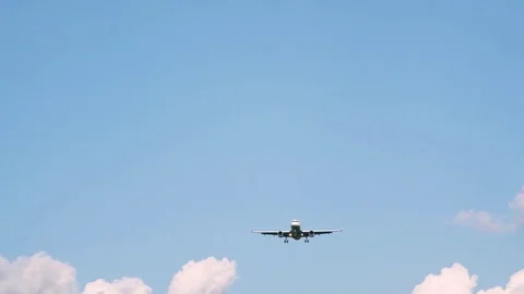 Plane flying through clouds in the sky. Jet aircraft in the air. Stock Footage 77767103