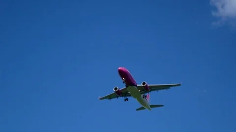 Plane flying through clouds in the sky. Jet aircraft in the air. Stock Footage 77767106