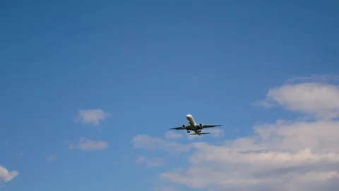 Plane flying through clouds in the sky. Jet aircraft in the air. Stock Footage 77767122