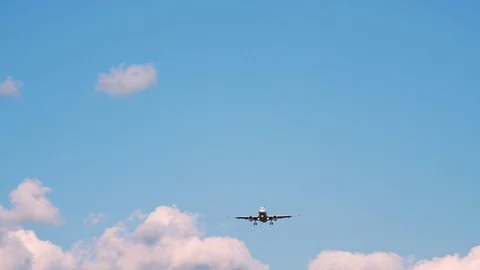 Plane flying through clouds in the sky. Jet aircraft in the air. Stock Footage 77767127