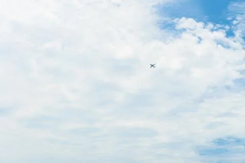 The plane is flying through clouds in the sky. Stock Photos