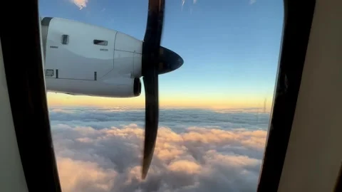 A plane is flying through the clouds at sunset 스톡 동영상 268442092