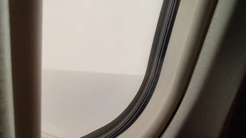 Plane flying through cloudy sky window perspective Stock Footage 122662723