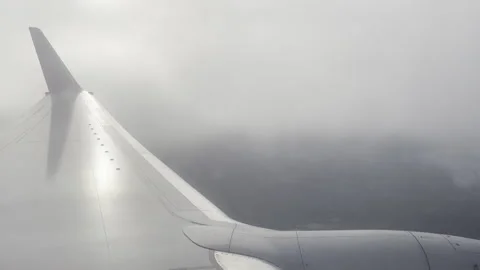 Plane Flying in Through Misty Clouds Video stock 240216439