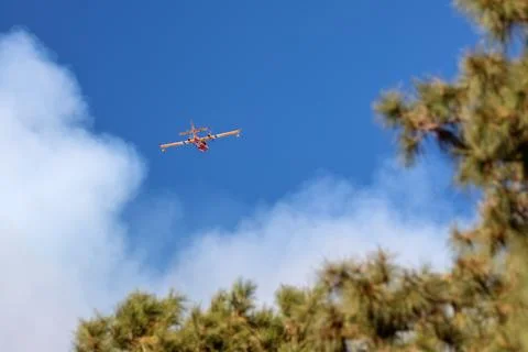 Plane flying towards the fire Stock Photos