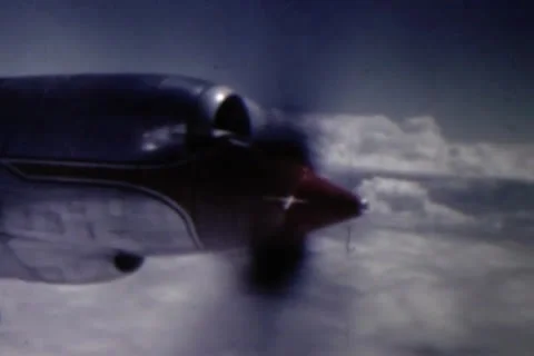 Plane fying  in clouds circa 1950's Stock Footage 24672555