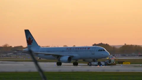 Plane getting towed at sunset Stock Footage 139664454