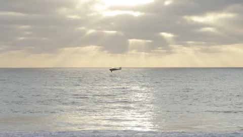 Plane Glides over the Water on the beach Stock Footage 167867493