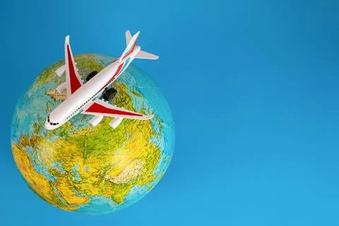 The plane on the globe from above, blue background. Map of the world. Stock Photos