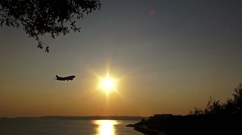 The Plane goes down over the Sea at Sunset Stock Footage 69013449