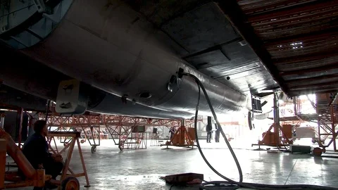 Plane IL-76 stands on hydraulic elevators Close-up Rackes chassis move down. Stock Footage 108802512