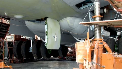 Plane IL-76 stands on hydraulic elevators. Rack chassis move down. Video stock 108866465