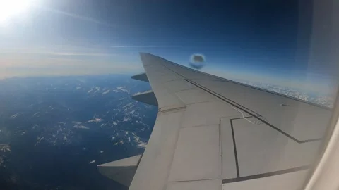 Plane inflight window view of flying over the European Alps Stock Footage 304263509