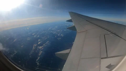 Plane inflight window view of flying over the European Alps Stock Footage 304263513