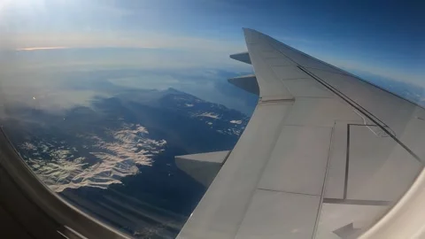 Plane inflight window view of flying over the European Alps Stock Footage 304263521