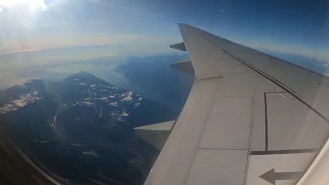 Plane inflight window view of flying over the European Alps Stock Footage 304263928