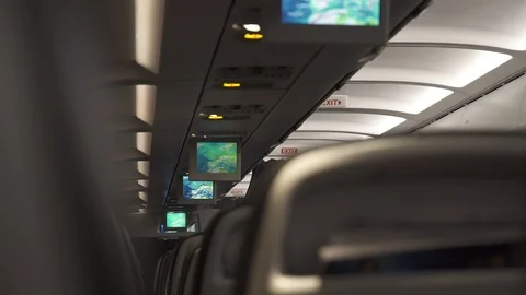 Plane interior cabin during flight, the monitors show the route Stock Footage 88499814