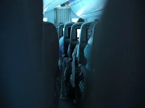 Plane interior cabin view shot after light dim for overnight flight Stock Footage 74877721