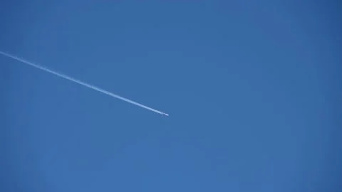 Plane jet-stream on empty blue sky Stock Footage 169831759