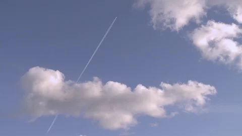 A plane jets through the sky in a wider shot Video stock 87115325