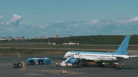 The plane landed and passengers go out on the ladder and go to the bus Stock Footage 92199228