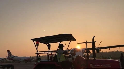 A plane landed , worker are busy to unload it in the evening . Stock Footage 145461592
