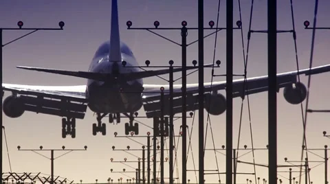 Plane landing in airport at sunset Stock Footage 7753578