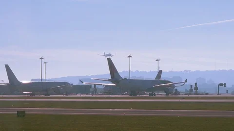 Plane landing and another big easyjet plane taxiing in the foreground Stock Footage 110816760