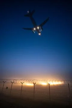 Plane landing during sunset at Riga Airport RIX Stock Photos
