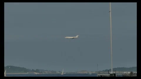 Plane landing at Logan viewed from Boston Harbor in 4k Stock Footage