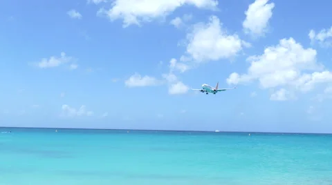 Plane landing low over the beach Stock Footage 65420172