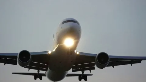 Plane landing over head at sunset Stock Footage 83488056