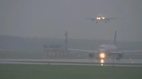 The plane landing on a rainy evening Stock-Footage 99264576