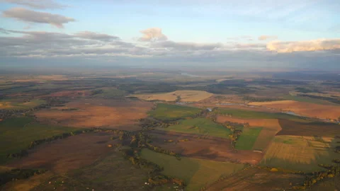 Plane landing. The reduction of a passenger plane over the countryside. View Stock Footage 140141009