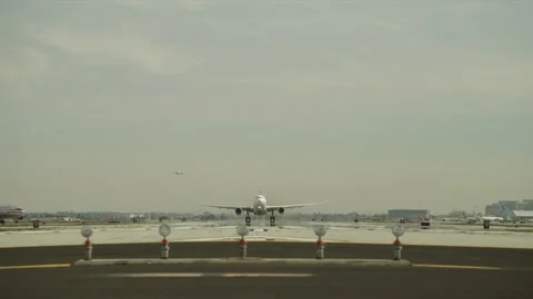 Plane landing on runway Stock Footage 197493042