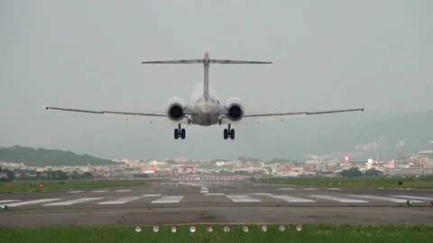 A plane landing at Song Shan Airport, Taipei, Taiwan Stock Footage 138633678