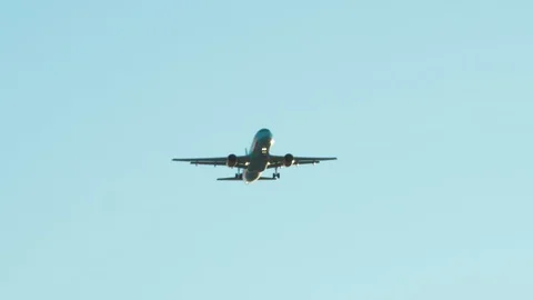 The plane lands against the blue sky. Aircraft is flying in the sky Stock Footage 125212791