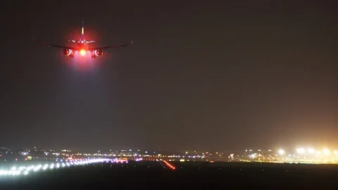 The plane lands at the airport at night. Stock Footage 106375893
