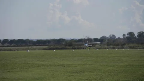Plane lands on a lawn Stock-Footage 141454867