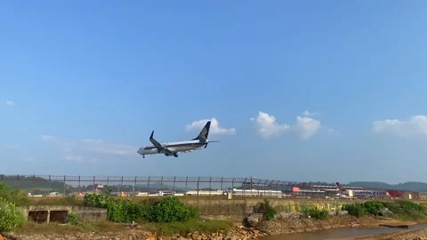 Plane lands low over the beach. Video stock 239523401