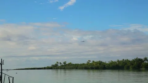 A plane lands, view from the shore of the beautiful Caribbean island. Stock Footage 201604183