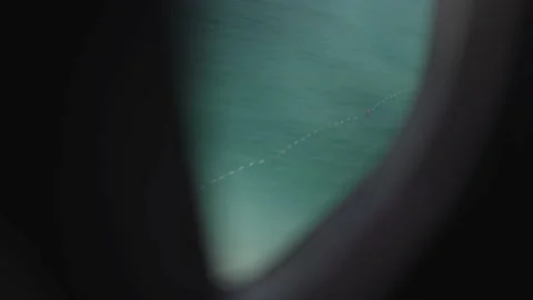 Plane lifting off from Caribbean island from inside window Stock Footage 168776960