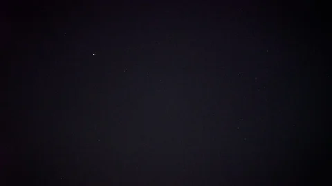 Plane lights blink in the vast night sky surrounded by stars. Vídeos de archivo 120048014